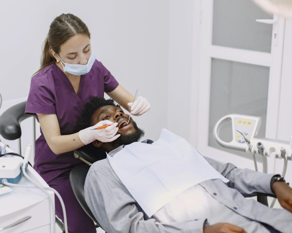 Dental Hygienist sitting to scale teeth