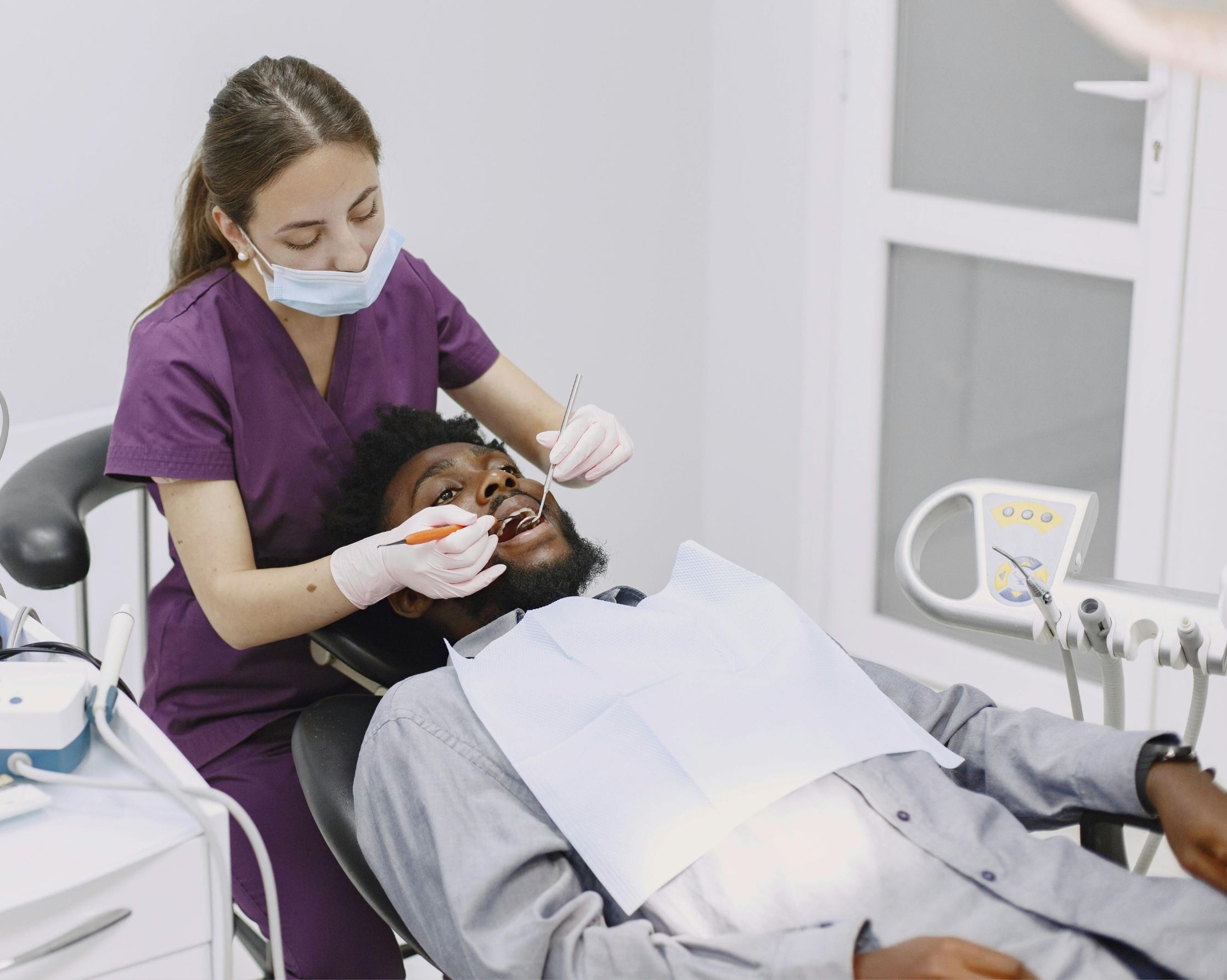 Dental Hygienist sitting to scale teeth